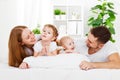 Happy family at home in the bed Royalty Free Stock Photo