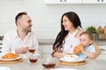 Happy family in home kitchen married couple with small child Royalty Free Stock Photo