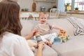 Happy family at home. Mother and baby boy playing with toys in couch at home indoors. Little toddler child and Royalty Free Stock Photo