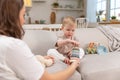 Happy family at home. Mother and baby boy playing with toys in couch at home indoors. Little toddler child and Royalty Free Stock Photo