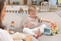 Happy family at home. Mother and baby boy playing with toys in couch at home indoors. Little toddler child and Royalty Free Stock Photo