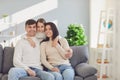 Happy family at home. Mother father and daughter sitting on sofa in room. Royalty Free Stock Photo