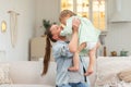 Happy family at home. Mother lifting in air little toddler child daughter. Mom and baby girl playing having fun together Royalty Free Stock Photo