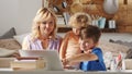 Happy family at home, mother with son and daughter have fun using computer, parent with children browsing internet on laptop, Royalty Free Stock Photo