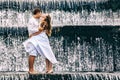 Happy family honeymoon holiday. Couple in cascade waterfall pool. Royalty Free Stock Photo