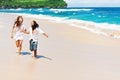 Young couple run by white sand beach along sea surf Royalty Free Stock Photo