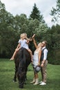 Happy family on the horse ranch walking with horse. Young happy family having fun at countryside outdoors, two girls Royalty Free Stock Photo