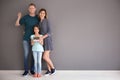 Happy family with house model and key at their new home Royalty Free Stock Photo