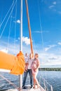 A happy family. Husband, pregnant wife and son on the yacht