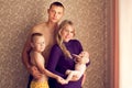 Happy family - husband, wife, son, and newborn baby posing at ho Royalty Free Stock Photo