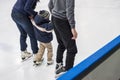 Family ice skating at rink. Winter activities Royalty Free Stock Photo