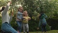 Happy family mother, two Three little siblings kids are blowing soap bubbles and enjoying summer holidays in garden or Royalty Free Stock Photo