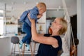 Happy family indoors. Portrait of beautiful mother with cute baby playing smiling together. Royalty Free Stock Photo