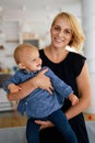 Happy family indoors. Portrait of beautiful mother with cute baby playing smiling together. Royalty Free Stock Photo