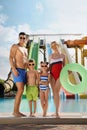 Happy family with inflatable ring near pool in water park Royalty Free Stock Photo