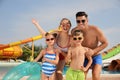 Happy family with inflatable ring near pool in water park Royalty Free Stock Photo