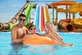 Happy family with inflatable ring in pool at water park Royalty Free Stock Photo