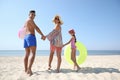 Happy family with inflatable toys at beach on sunny summer day Royalty Free Stock Photo