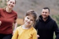 Happy family jogging in the summertime. Smiling young couple with their cute daughter doing sport Royalty Free Stock Photo