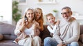 Happy family joyful little children hugging embracing with positive senior grandparents at home Royalty Free Stock Photo