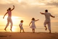 Happy family jumping on the beach Royalty Free Stock Photo