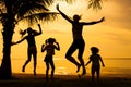 Happy family jumping on the beach Royalty Free Stock Photo