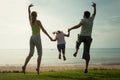 Happy family jumping on the beach Royalty Free Stock Photo