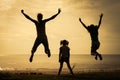 Happy family jumping on the beach Royalty Free Stock Photo