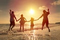 Happy family jumping on the beach Royalty Free Stock Photo