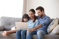 Happy family with kid daughter enjoy using laptop at home Royalty Free Stock Photo