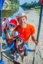 Happy family with kid enjoying kayak ride on beautiful river. Little boy and teenager girl kayaking on hot summer day Royalty Free Stock Photo