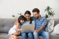 Happy family with kid girl having fun using laptop together Royalty Free Stock Photo
