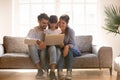 Happy family with kid using laptop together on sofa Royalty Free Stock Photo