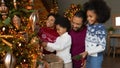 Happy family with kids decorate Christmas tree together