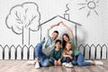 Happy family with kids dreaming about house. Illustrations on brick wall