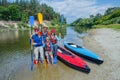 Happy family with kids enjoying kayak ride on beautiful river. Little boy and teenager girl kayaking on hot summer day Royalty Free Stock Photo