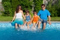 Happy family with kids having fun near pool on vacation Royalty Free Stock Photo