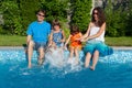 Happy family with kids having fun near pool on vacation Royalty Free Stock Photo