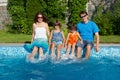 Happy family with kids having fun near pool on vacation Royalty Free Stock Photo