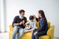 Happy family and kids  playing the ukulele sitting on sofa , Mother and father encourage together with daughter Royalty Free Stock Photo