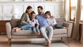 Happy family with kids relax on couch using cell Royalty Free Stock Photo