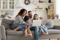 Happy family with kids sit on couch using laptop Royalty Free Stock Photo