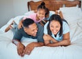 Happy family with kids, smile and lying on bed in home, mother and father with children together in Mexico. Love, fun Royalty Free Stock Photo