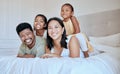 Happy family with kids, smile and lying on bed in home, portrait of mother, father and children together in Asia. Love Royalty Free Stock Photo