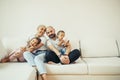 Happy family with kids on sofa Royalty Free Stock Photo