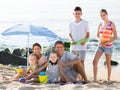 Happy family with kids together on beach sitting Royalty Free Stock Photo