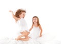 Happy family . kids twin sisters jumping on the bed, playing an Royalty Free Stock Photo