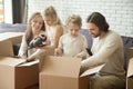 Happy family with kids unpacking boxes moving in new home Royalty Free Stock Photo