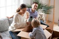 Happy family with kids unpacking boxes moving into new home Royalty Free Stock Photo