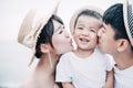 Happy family kissing the child on the